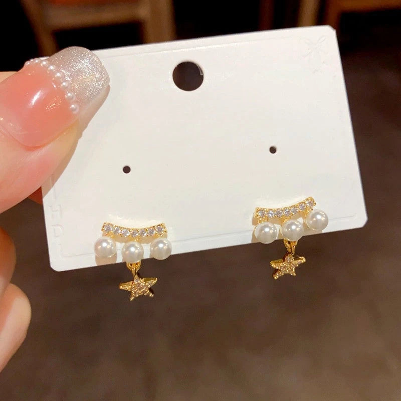 Close-up detail of the sparkling zircons and plating on the Pearl Star Earrings