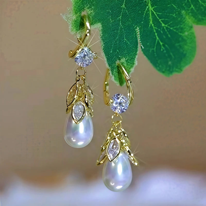 Elegant gold leaf teardrop pearl dangle earrings with cubic zirconia accents