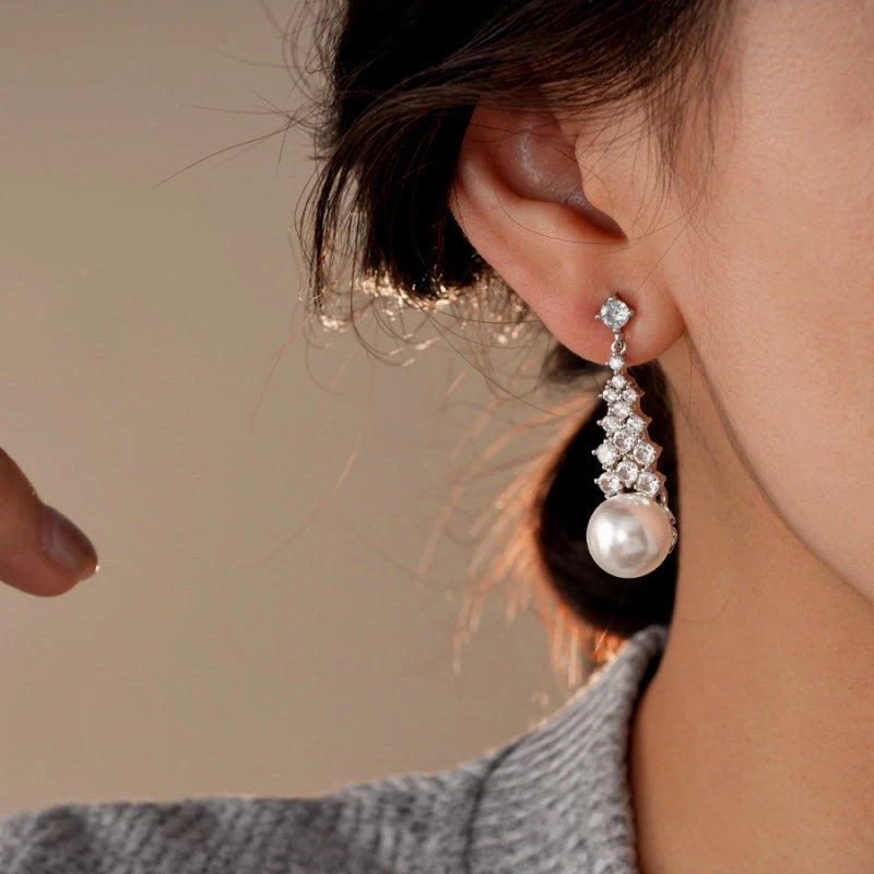 Model showcasing the dangle and style of the 14K Gold-Plated Zircon Pearl Tassel Earrings