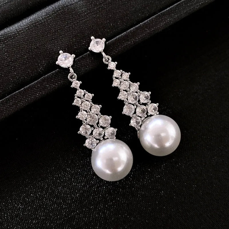Angled view of the 14K Gold-Plated Zircon Pearl Tassel Earrings