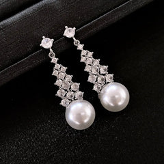 Angled view of the 14K Gold-Plated Zircon Pearl Tassel Earrings