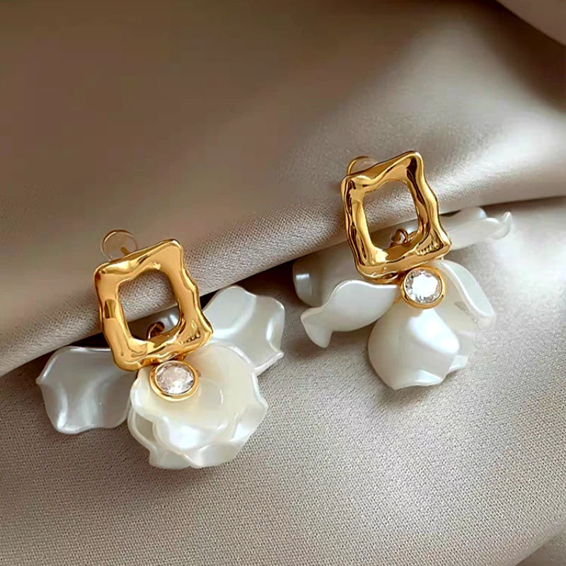 Model showcasing the dangle and style of the 14K Gold-Plated Zircon Petal Flower Earrings