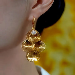 Model showcasing the dangle and style of the 14K Gold-Plated Zircon Petal Tassel Earrings