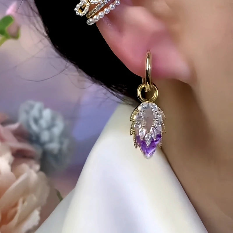 Model showcasing the dangle and style of the 14K Gold-Plated Zircon Purple Crushed Ice Double-Layer Leaf Tassel Earrings