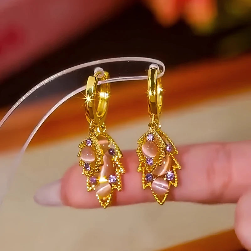 Pair of Gold Leaf Drop Earrings with Pink Opal & Purple Crystals on Display Stand