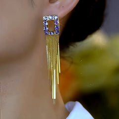 Model showcasing the dangle and style of the 14K Gold-Plated Zircon Purple Diamond Tassel Earrings