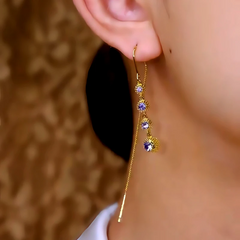 Model showcasing the dangle and style of the 14K Gold-Plated Zircon Purple Diamond Threader Tassel Earrings