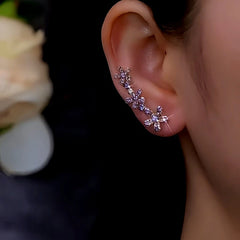 Purple rhinestone flower ear climber earring worn on right ear