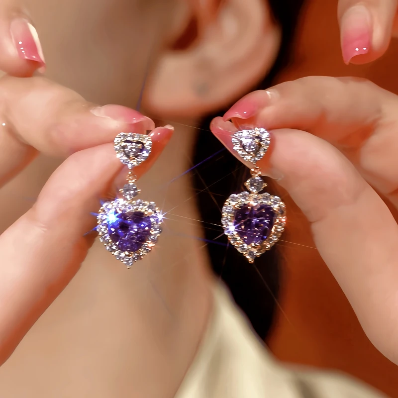 Angled view of the 14K Gold-Plated Zircon Purple Heart Earrings