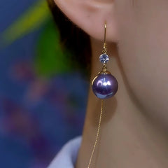 Model showcasing the dangle and style of the 14K Gold-Plated Zircon Purple Pearl Threader Earrings