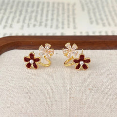 Angled view of the 14K Gold-Plated Zircon Red Flower Earrings