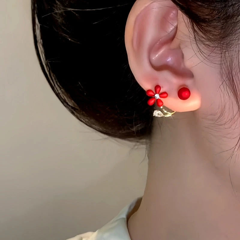 Model showcasing the dangle and style of the 14K Gold-Plated Zircon Red Flower Pearl Jacket Earrings