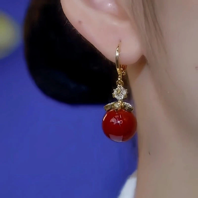 Close-up detail of the sparkling zircons and plating on the Red Pearl Earrings