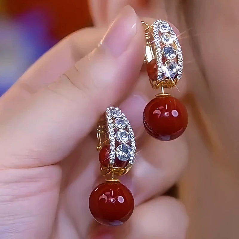 Close-up detail of the sparkling zircons and plating on the Red Pearl Earrings