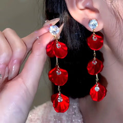 Red rose petal crystal stud drop earrings, side view with one worn, one held