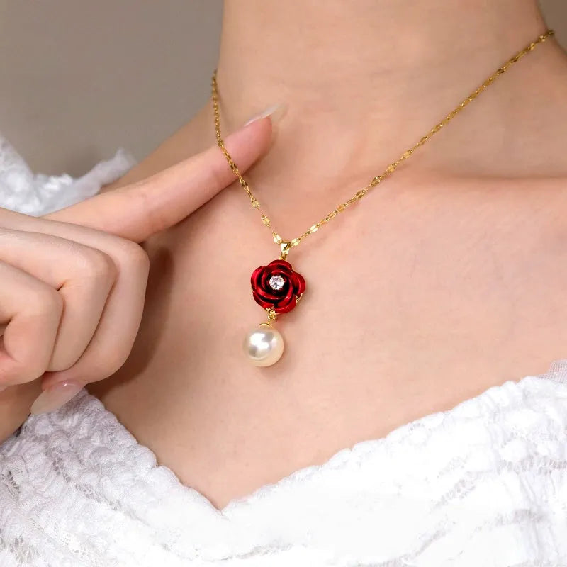 Close-up of red rose pearl gold pendant necklace with hand highlighting design