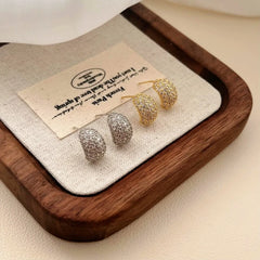 Close-up detail of the sparkling zircons and plating on the C-Shaped Earrings