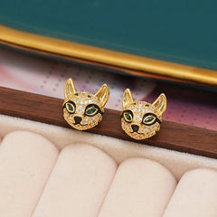 Pair of gold pave crystal cat head stud earrings with green gem eyes