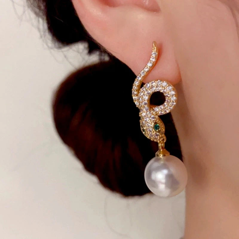 Model showcasing the dangle and style of the 14K Gold-Plated Zircon Snake-Shaped Pearl Earrings