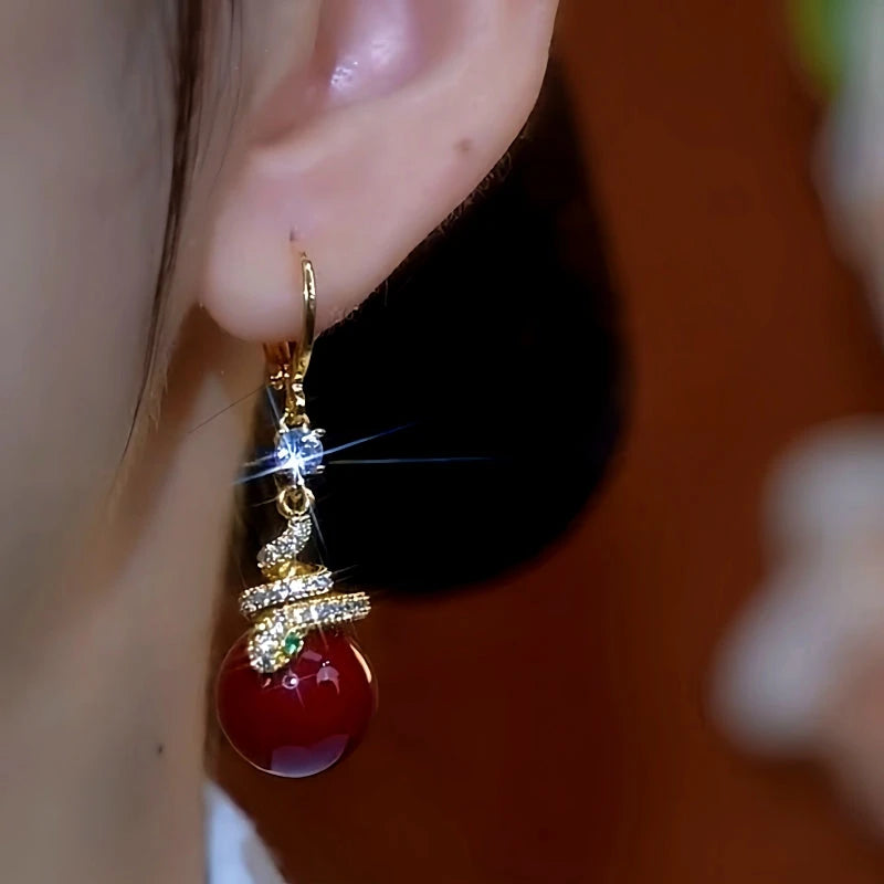 Model showcasing the dangle and style of the 14K Gold-Plated Zircon Snake-Shaped Pearl Earrings