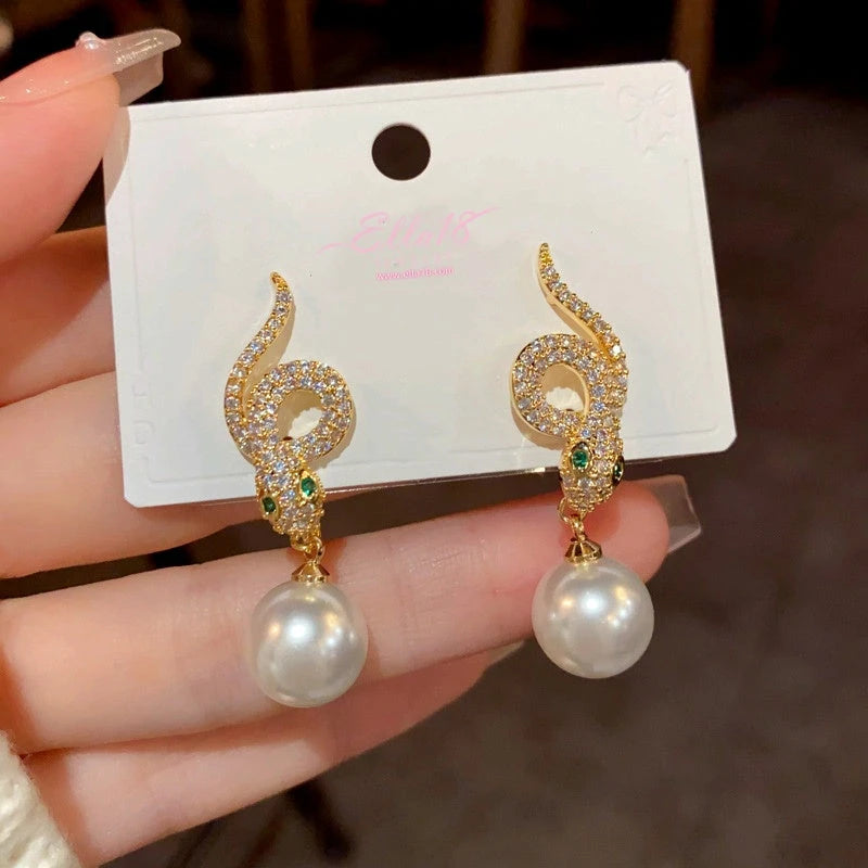 Angled view of the 14K Gold-Plated Zircon Snake-Shaped Pearl Earrings
