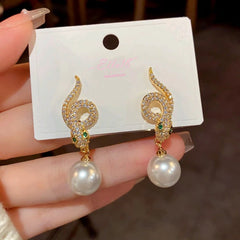 Angled view of the 14K Gold-Plated Zircon Snake-Shaped Pearl Earrings