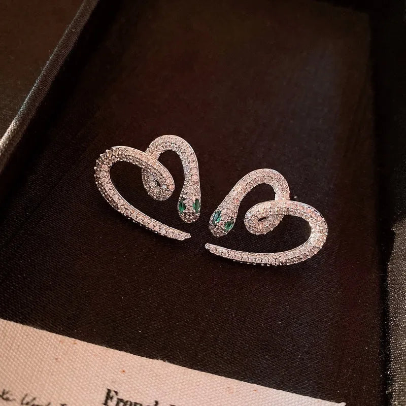 Angled view of the 14K Gold-Plated Zircon Snake Heart Stud Earrings