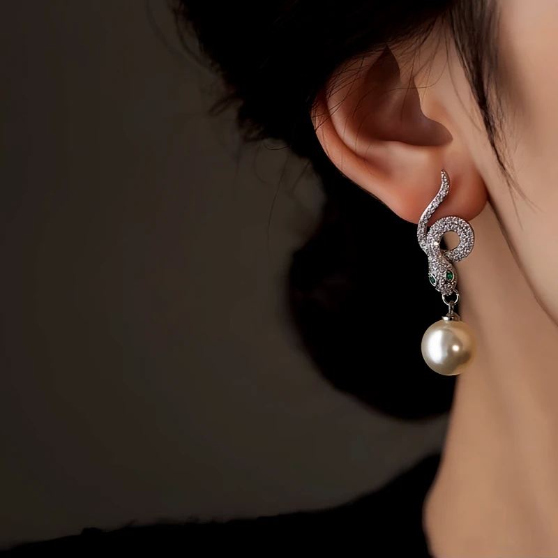 Close-up detail of the sparkling zircons and plating on the Snake Pearl Earrings