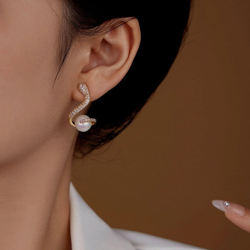 Close-up detail of the sparkling zircons and plating on the Snake Pearl Earrings
