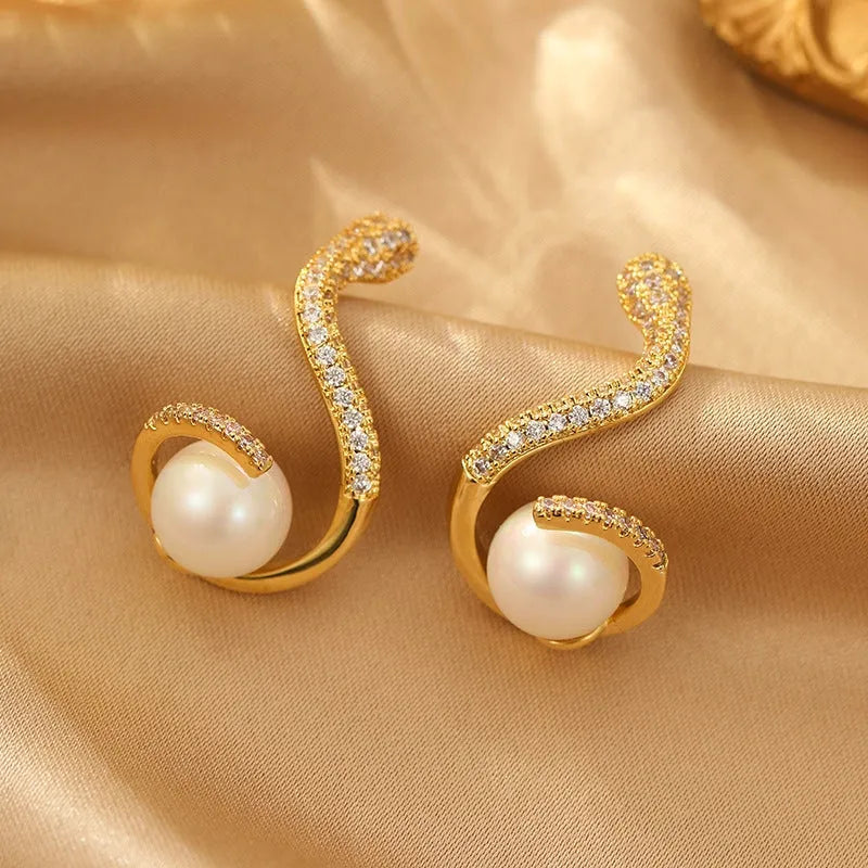 Angled view of the 14K Gold-Plated Zircon Snake Pearl Earrings