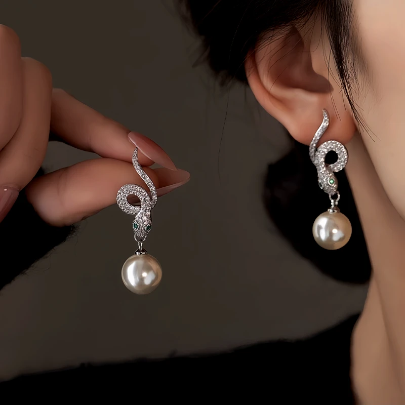 Model showcasing the dangle and style of the 14K Gold-Plated Zircon Snake Pearl Earrings
