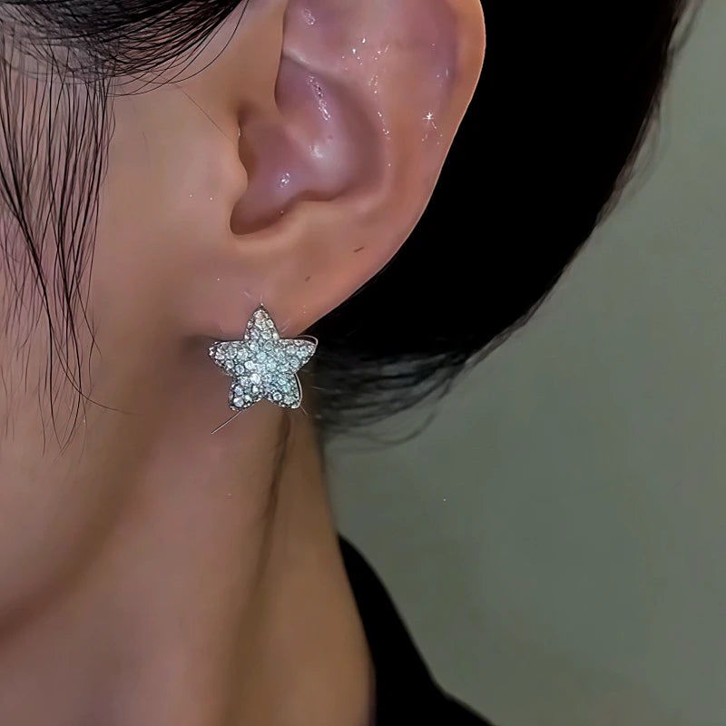 Model showcasing the dangle and style of the 14K Gold-Plated Zircon Star Earrings
