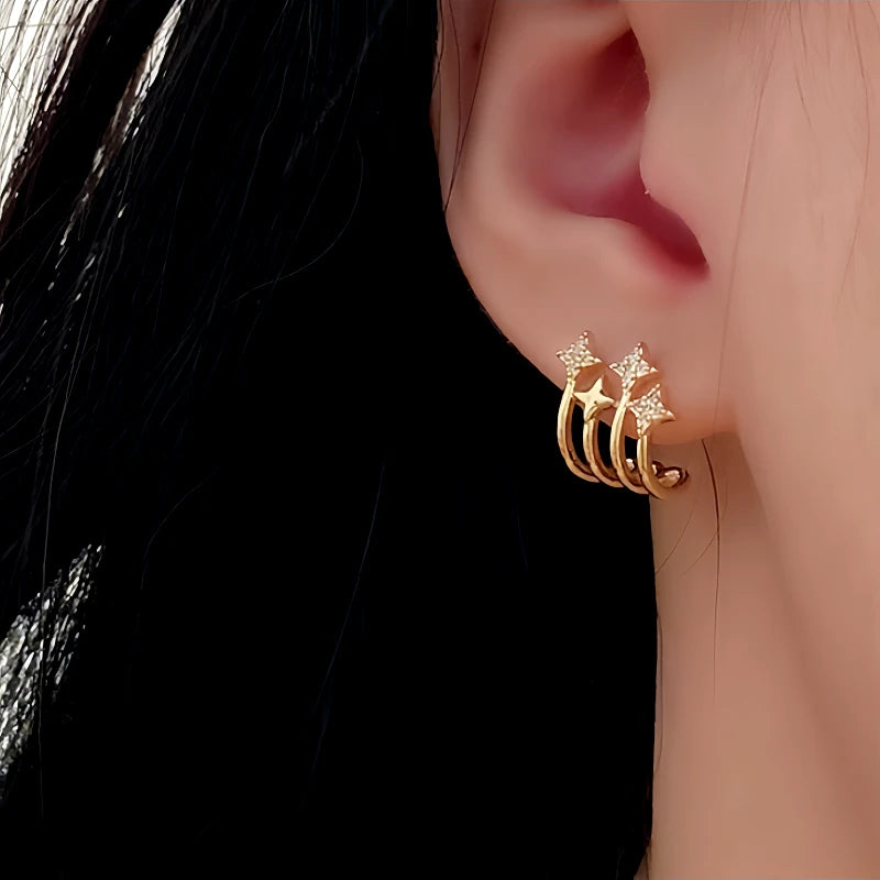 Model showcasing the dangle and style of the 14K Gold-Plated Zircon Star Stud Earrings
