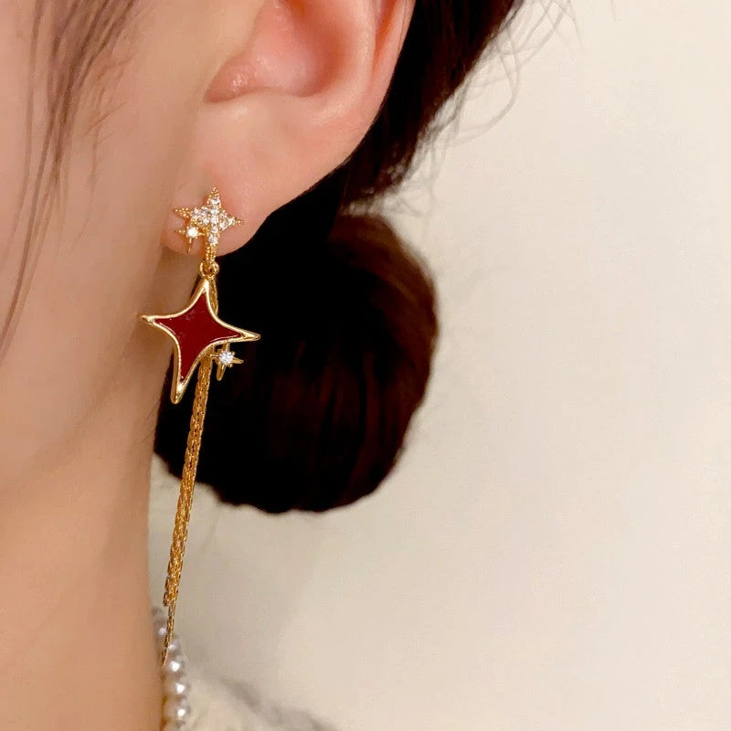 Model showcasing the dangle and style of the 14K Gold-Plated Zircon Star Tassel Earrings