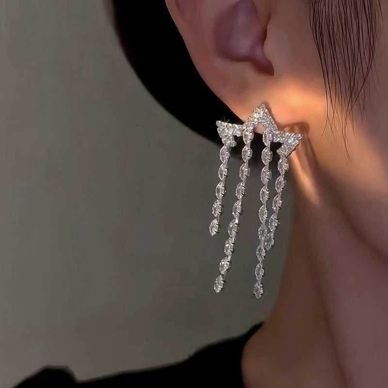 Model showcasing the dangle and style of the 14K Gold-Plated Zircon Star Tassel Earrings
