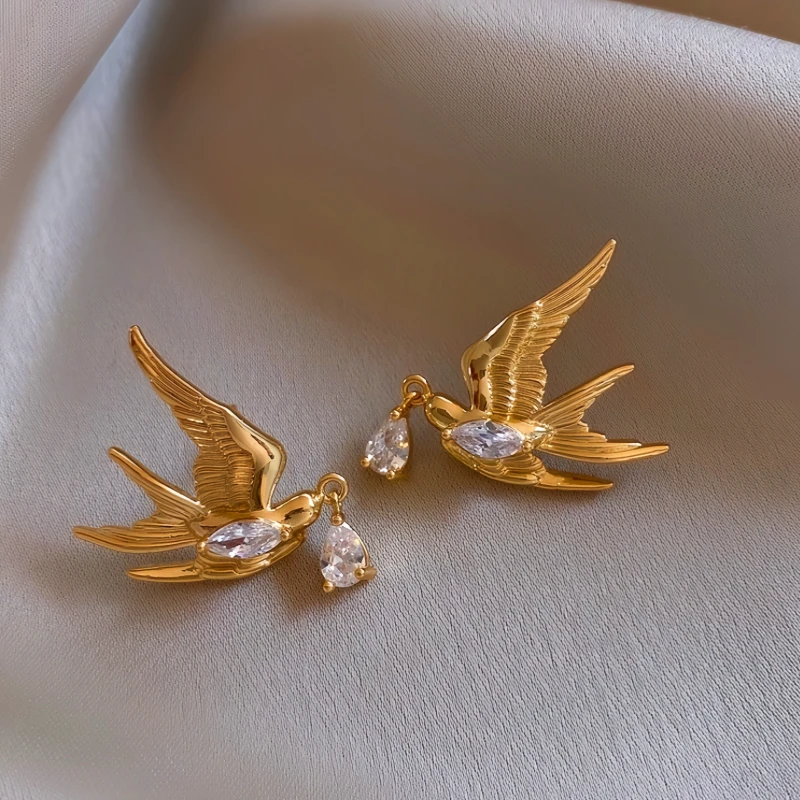 Angled view of the 14K Gold-Plated Zircon Swallow Water Drop Earrings