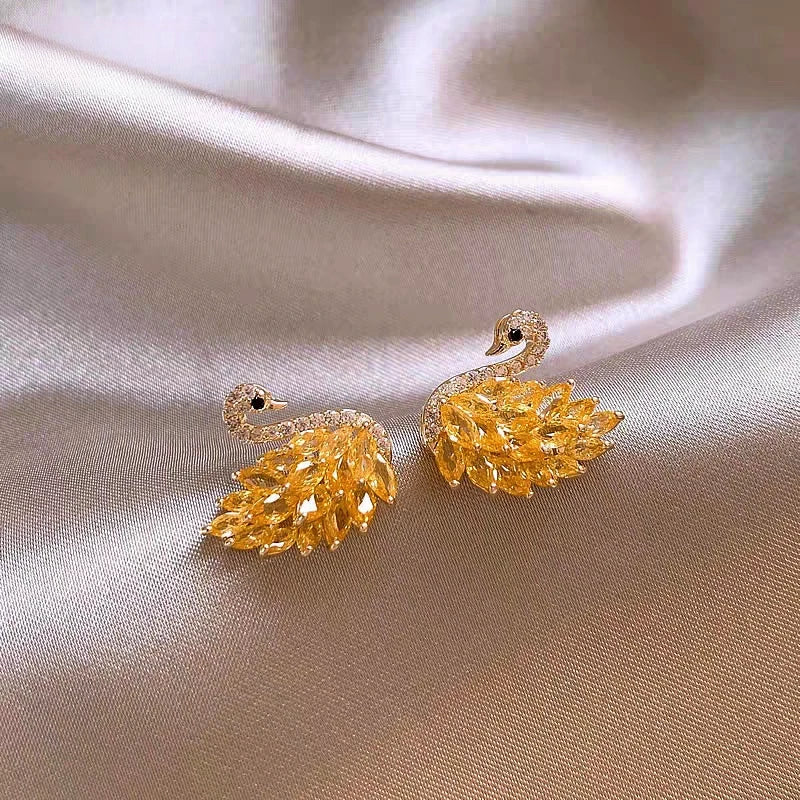 Angled view of the 14K Gold-Plated Zircon Swan Stud Earrings