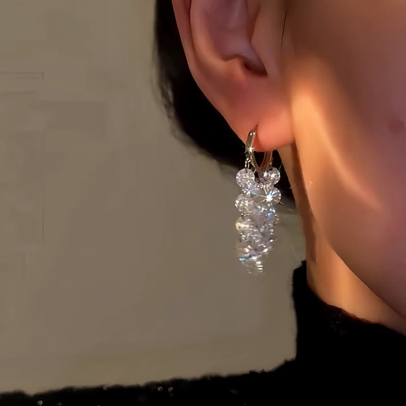 Close-up detail of the sparkling zircons and plating on the gold tassel earrings