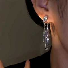 Model showcasing the dangle and style of the 14K Gold-Plated Zircon Tassel Earrings
