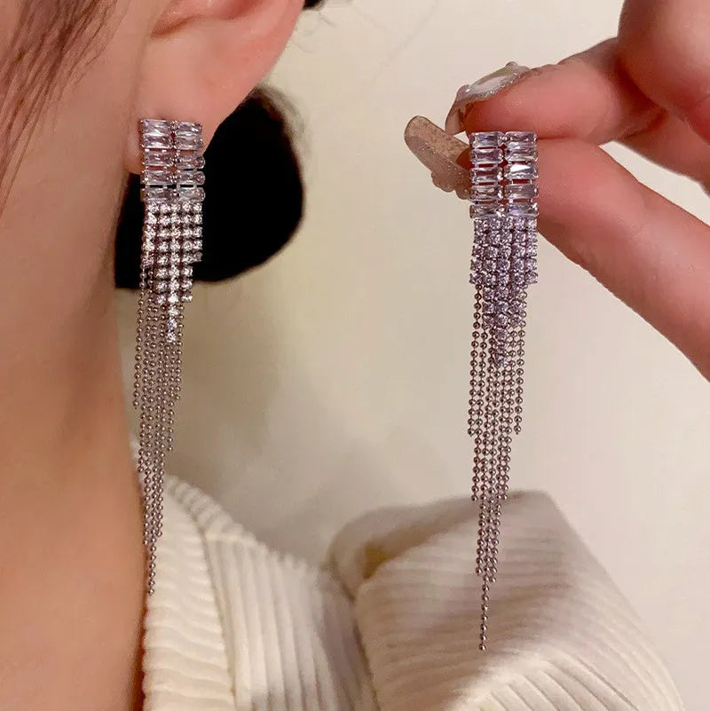 Model showcasing the dangle and style of the 14K Gold-Plated Zircon Tassel Earrings