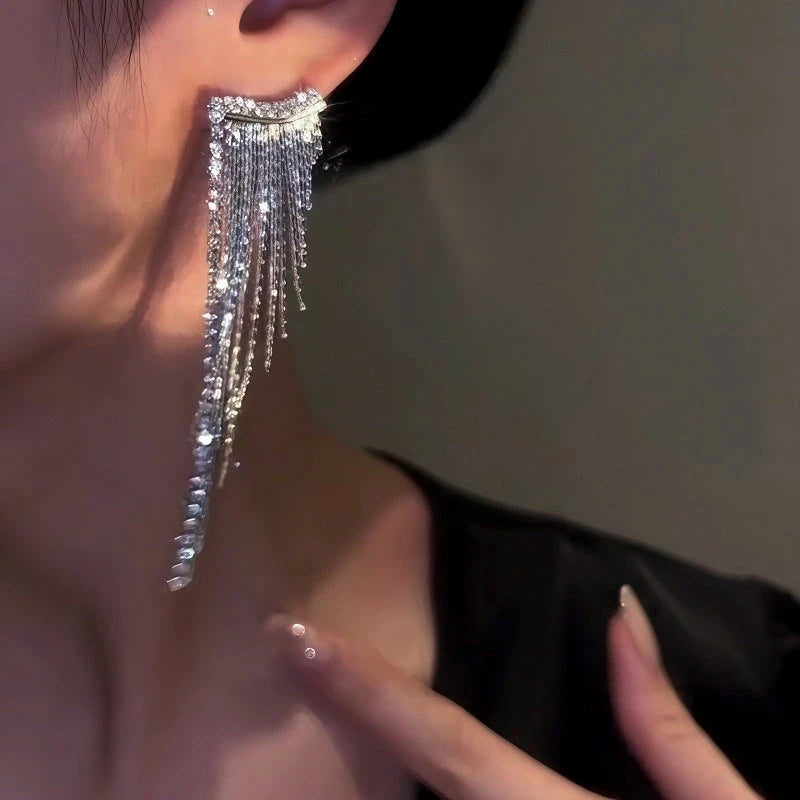 Model showcasing the dangle and style of the 14K Gold-Plated Zircon Tassel Earrings