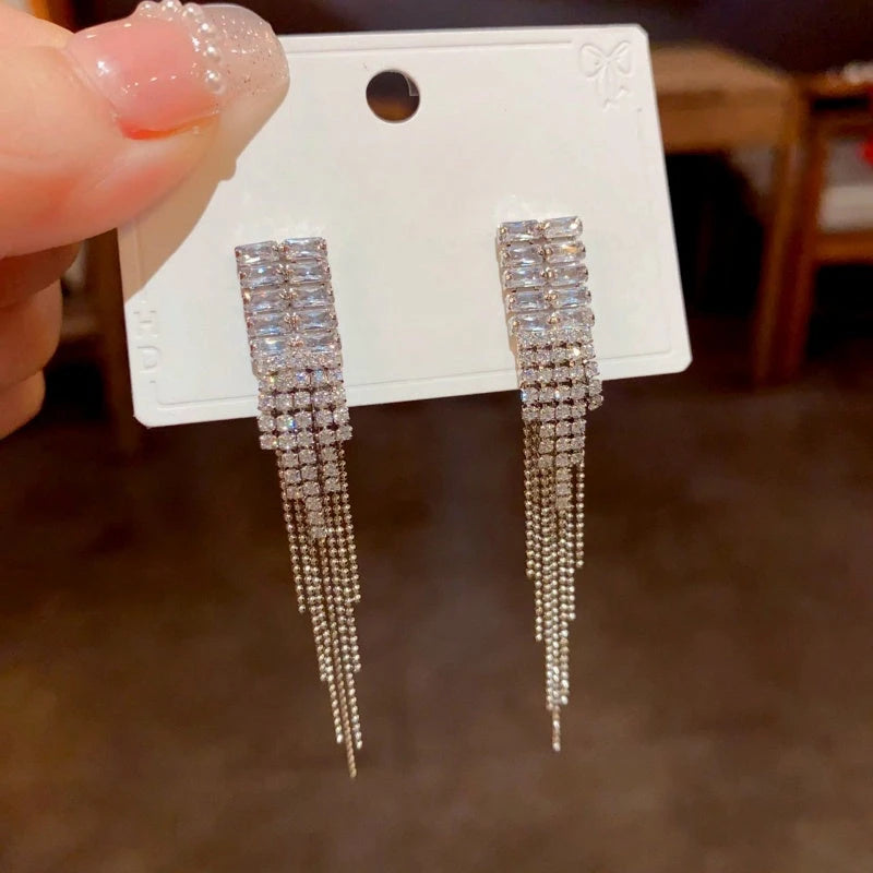 Angled view of the 14K Gold-Plated Zircon Tassel Earrings