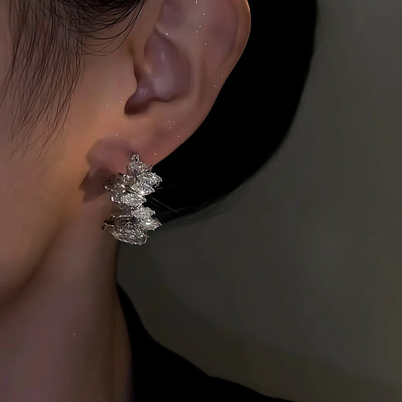 Close-up detail of the sparkling zircons and plating on the Toothed Hoop Earrings
