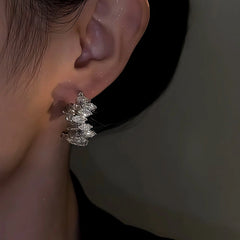 Close-up detail of the sparkling zircons and plating on the Toothed Hoop Earrings