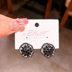 Close-up detail of the sparkling zircons and plating on the Black Flower Earrings