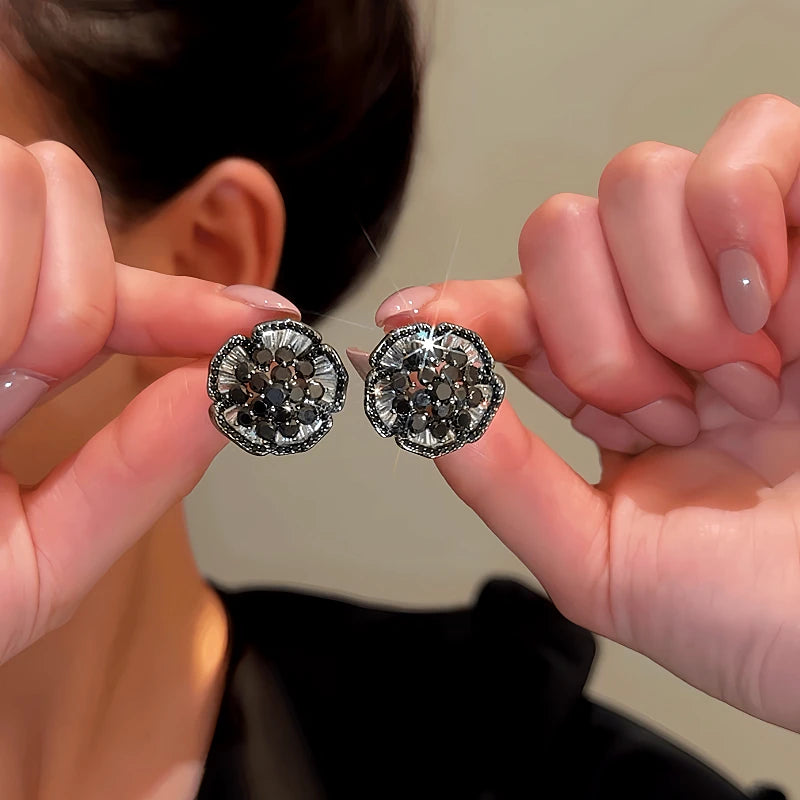 Angled view of the 14K Gold-Plated Zircon Vintage Black Flower Earrings