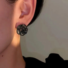 Model showcasing the dangle and style of the 14K Gold-Plated Zircon Vintage Black Flower Earrings