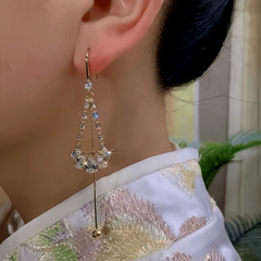 Model showcasing the dangle and style of the 14K Gold-Plated Zircon Water Drop Ear Hook Tassel Earrings