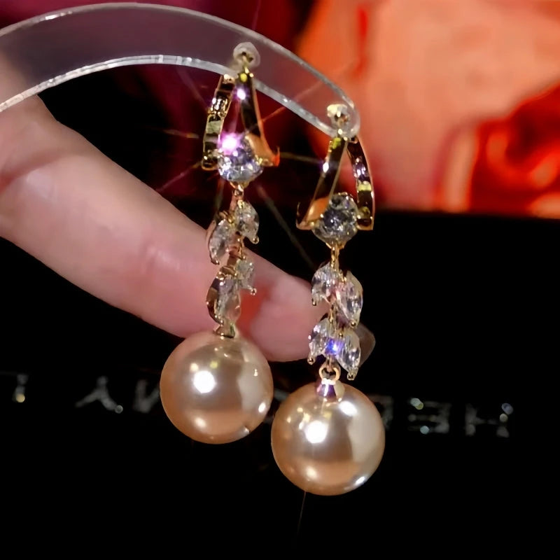 Model showcasing the dangle and style of the 14K Gold-Plated Zircon Wheat Pearl Earrings