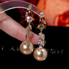 Model showcasing the dangle and style of the 14K Gold-Plated Zircon Wheat Pearl Earrings